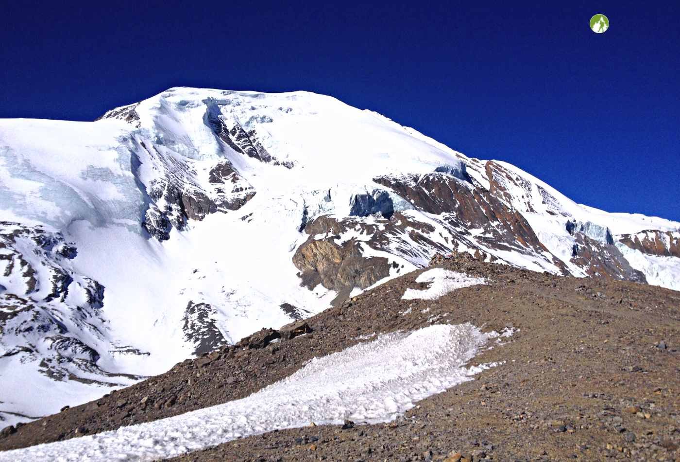 A majestic view of Throng peak (6,144m) during the Annapurna Circuit trek. The peak stands tall in the background, with a blanket of snow covering its summit.