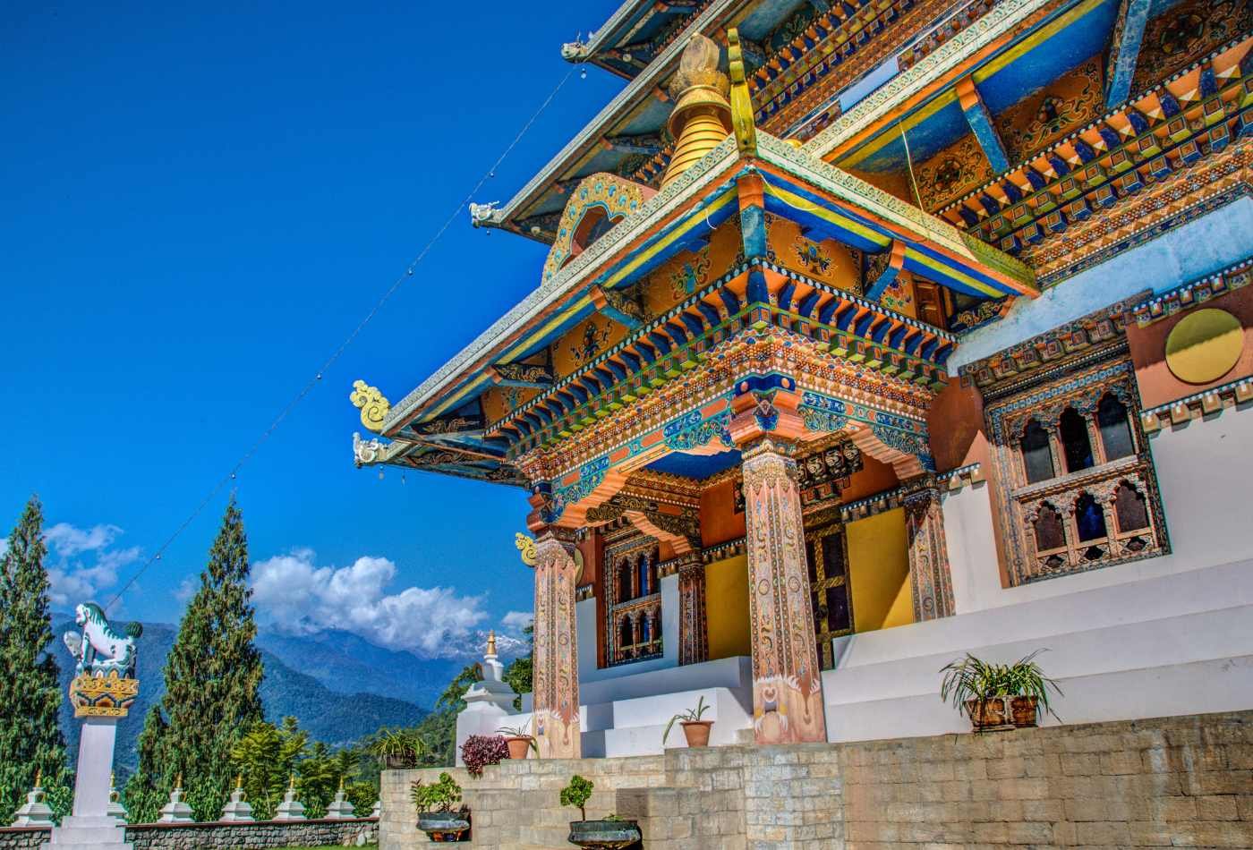 The entrance to the Khamsum Yuelley Namgyal Chorten, an important Bhutanese temple, characterized by its intricate carvings and colorful designs.