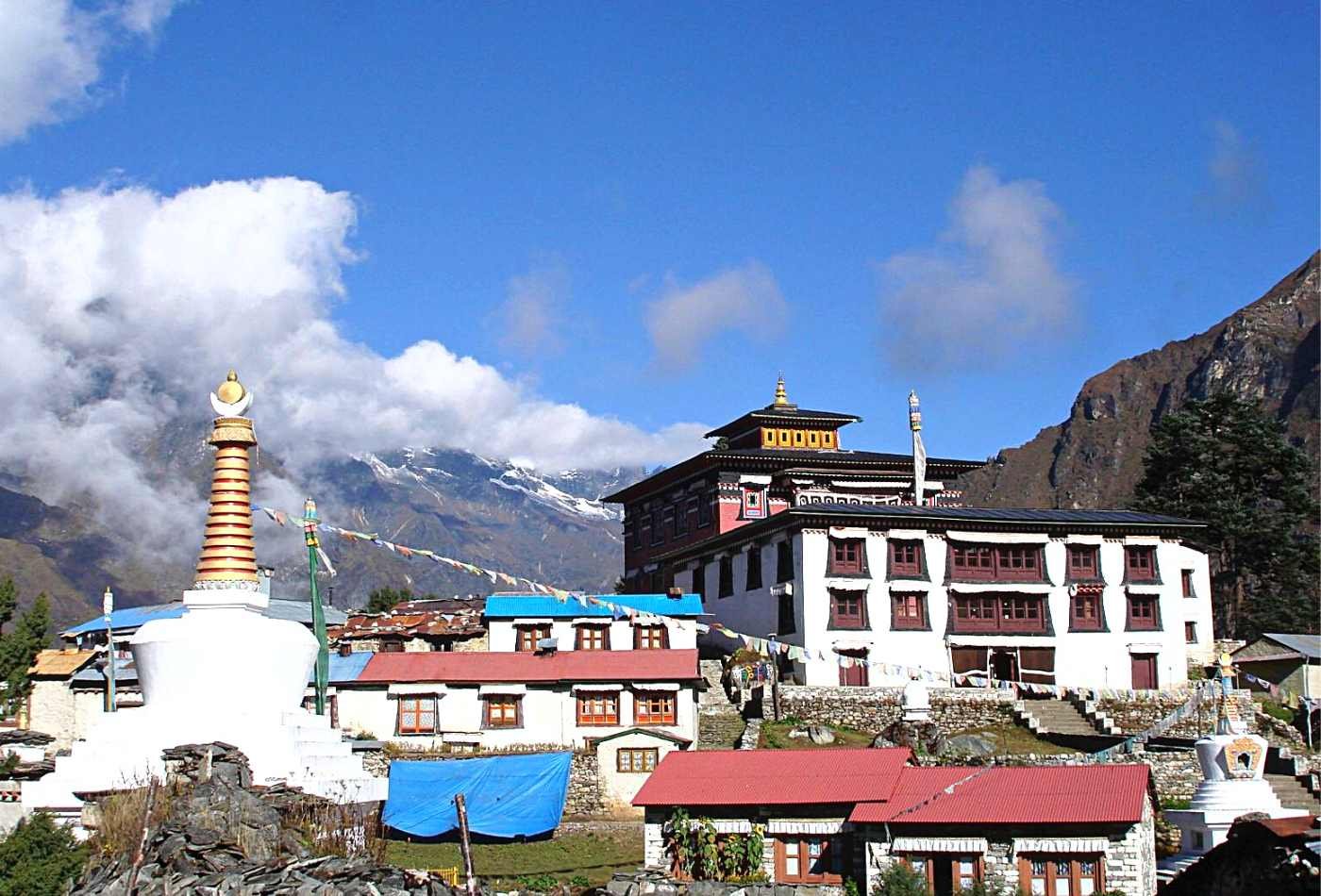 Tengboche Monastery, a traditional Tibetan Buddhist monastery located on the trek to Mount Everest Base Camp with red roof and white stupa. 