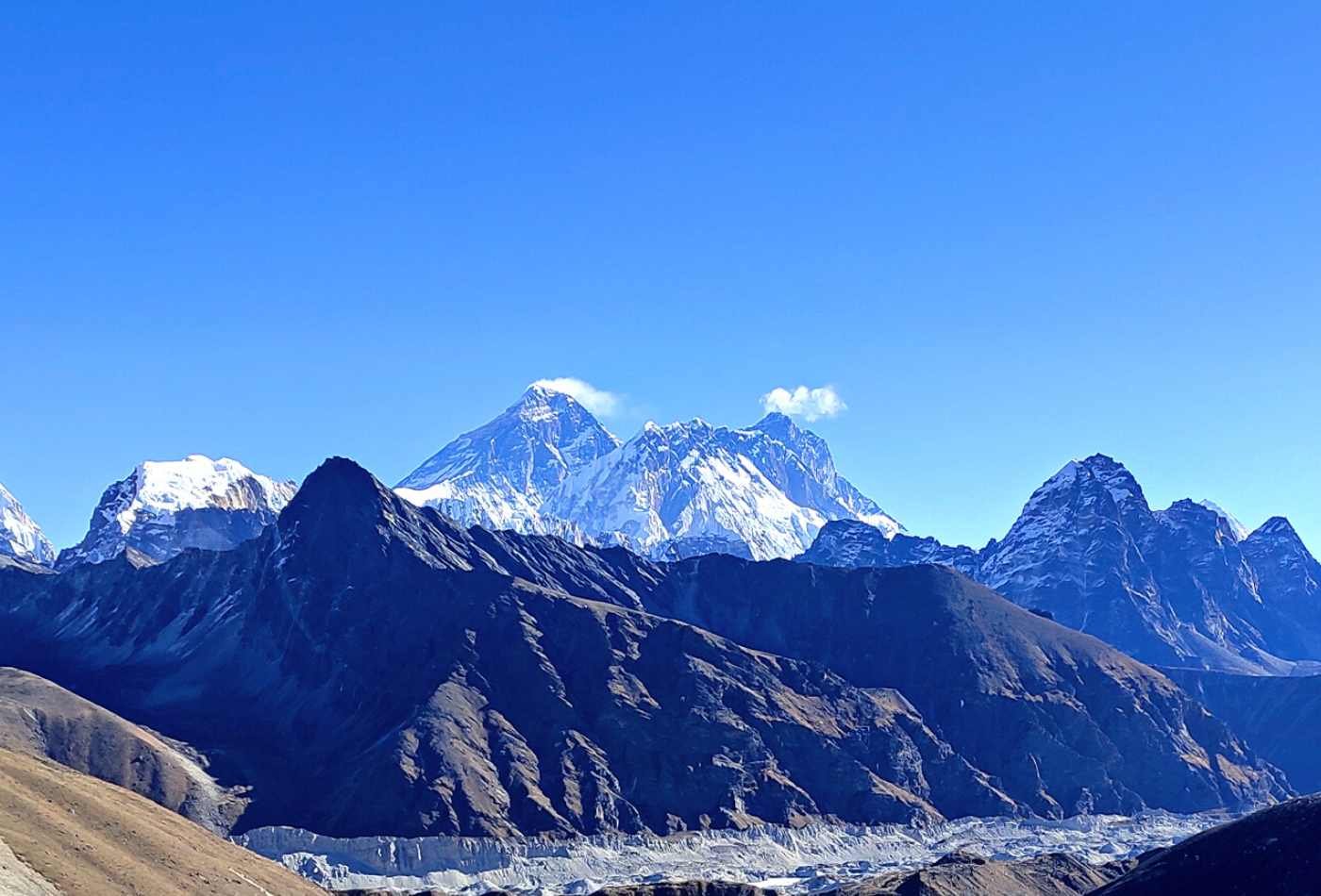 Mountain range view from Renjo-la pass in Khumbu Region, with Mt. Everest, Nuptse, and Lhotse visible in the distance on a clear day.