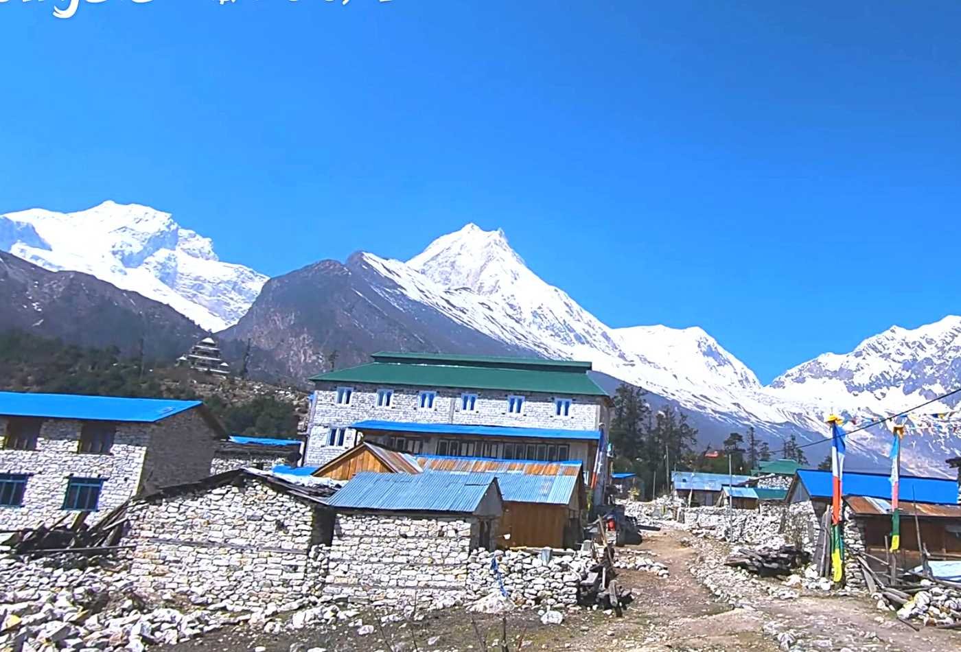 A stunning panoramic view of Mt. Manaslu and the Ngadi Chili peak, captured from Lho village on the Manaslu Circuit Trek.