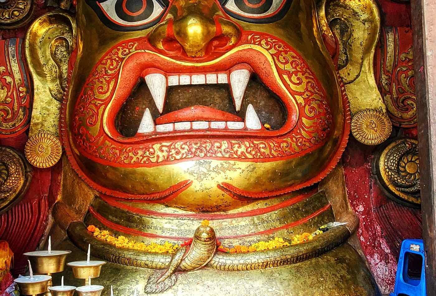 An image of the Swet Bhairab, with an opening mouth where two lower and two upper white teeth are visible, gives appearance of a fierce expression.