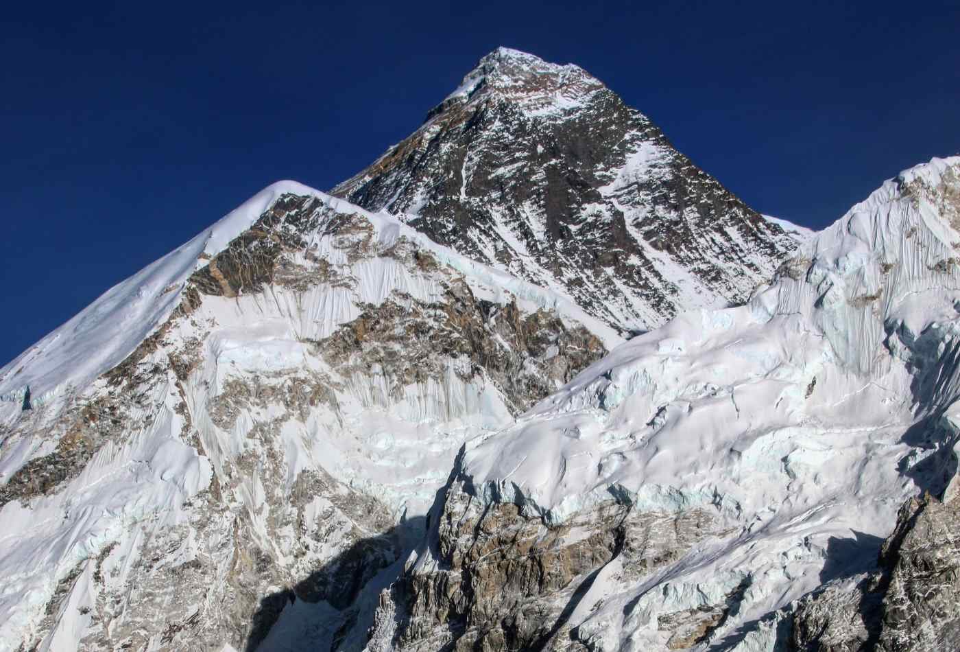 An awe-inspiring view of Mount Everest, as seen from the summit of Gokyo-ri, with the peak of the mountain towering above the surrounding landscape.