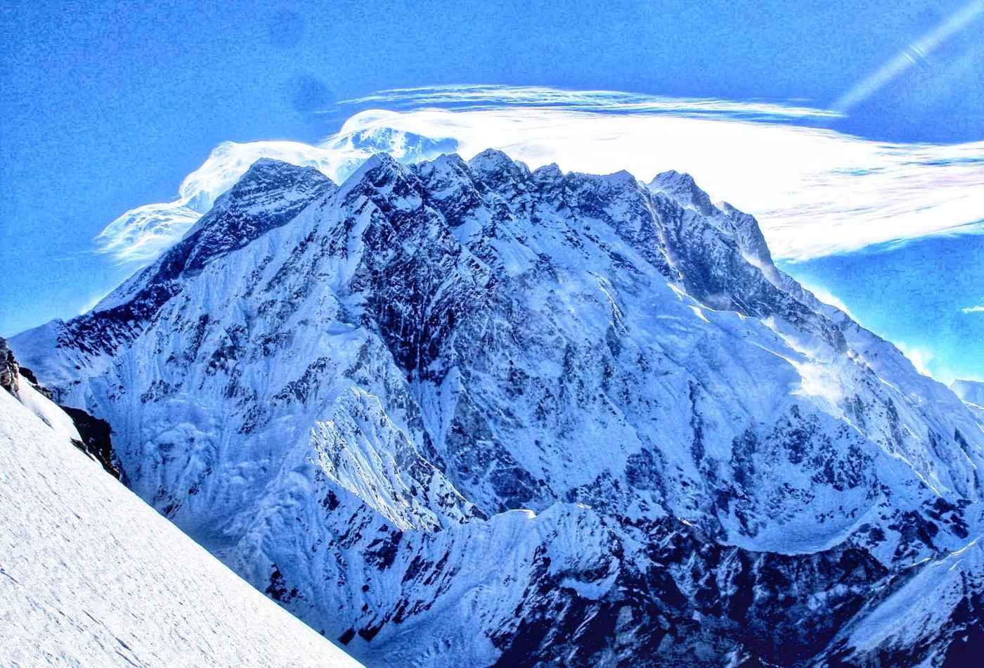 Above the surrounding landscape, there is a stunning view of Mt. Everest and Mt. Nuptse from the summit of Labuche Peak.