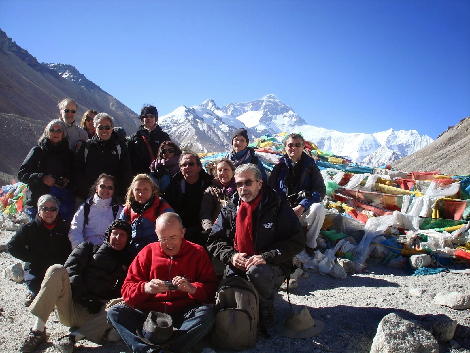 Tourist standing in front of Mt. Everest Base Camp in Tibet.